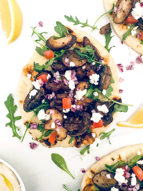 Thick pita layered with mushroom gyro and arugula.