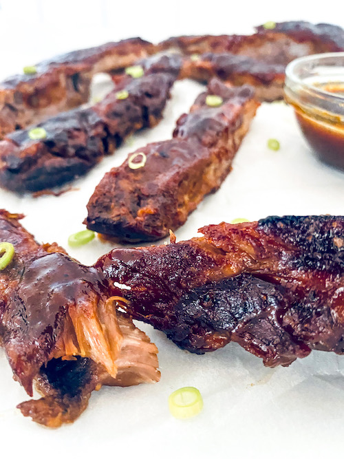 Pineapple BBQ ribs on a white surface.
