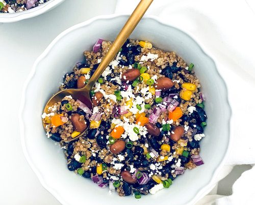 A white bowl of quinoa burrito bowl.