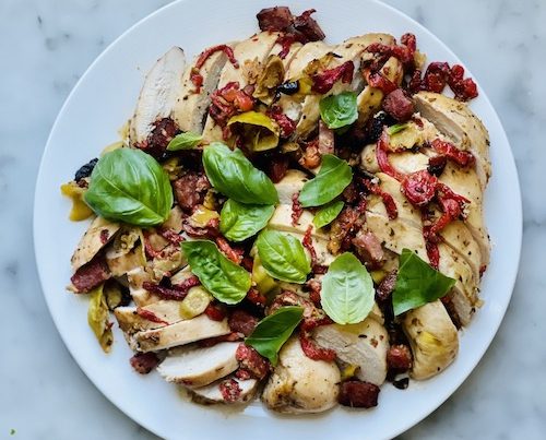 Tangy Italian chicken sheet pan dinner on a white plate.