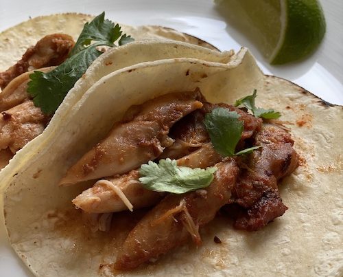Brown sugar chipotle chicken slices in corn tortillas.