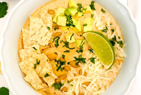 A large white bowl filled with creamy white vegetarian chili.