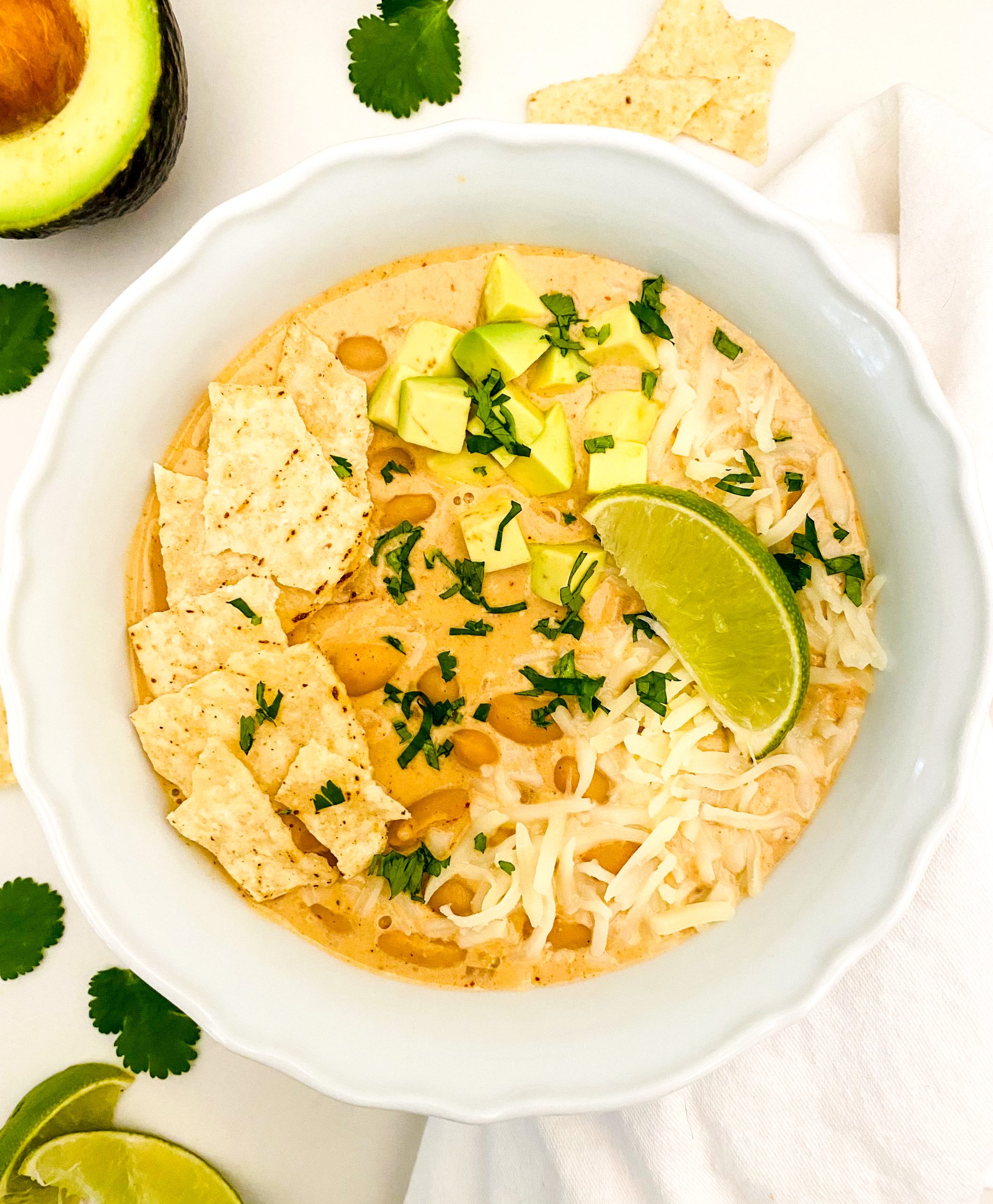 A large white bowl filled with creamy white vegetarian chili.