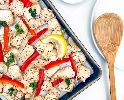 Sheet Pan Greek Chicken on a parchment lined baking sheet.