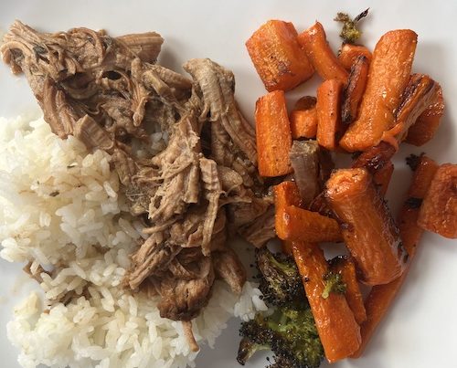 Mongolian beef, white rice, and roasted carrots on a white plate.