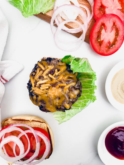 Cheddar burgers and lettuce with all the toppings.