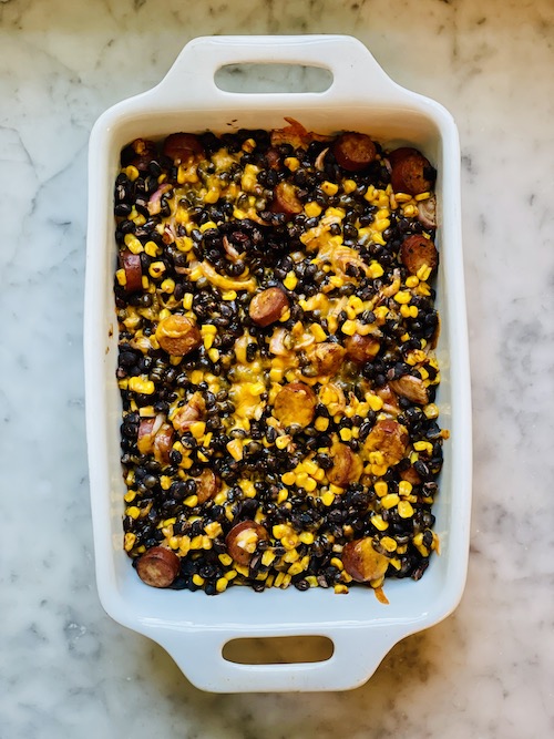 Black bean chorizo bake in a white baking dish.