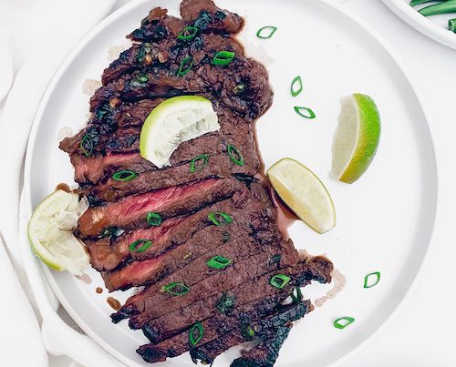 Vietnamese style steak on a white plate.