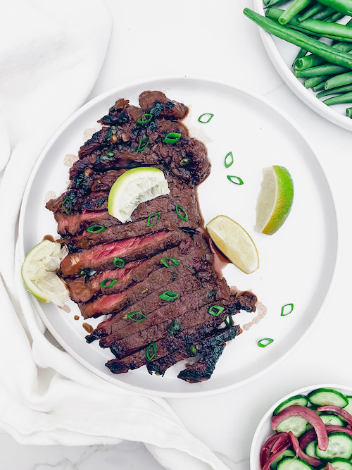 Vietnamese style steak on a white plate.