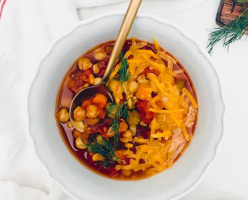 A small white bowl of buffalo chickpea chili.