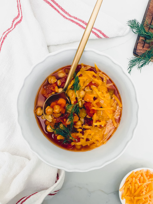 A small white bowl of buffalo chickpea chili.