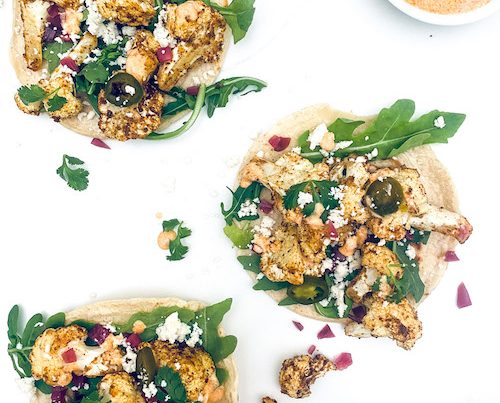 Cauliflower Tacos open on a white counter.
