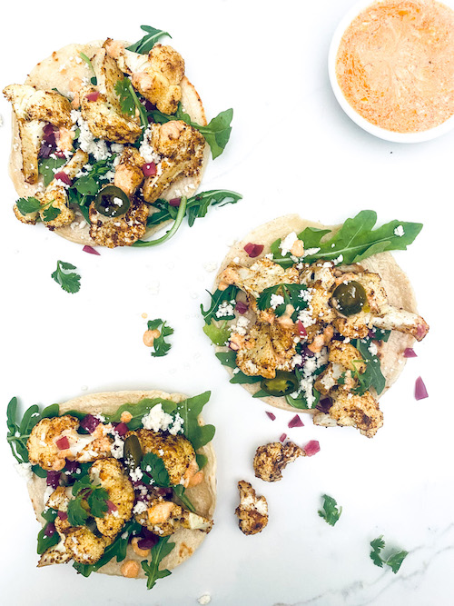 Cauliflower Tacos open on a white counter.
