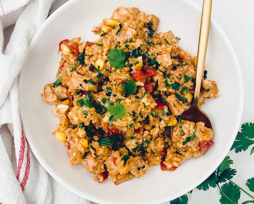 Creamy chicken burrito bowl in a large white bowl.