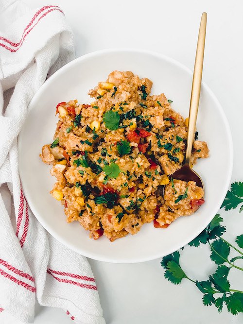 Creamy chicken burrito bowl in a large white bowl.