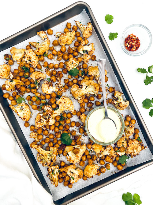 Sheet Pan Dorito Cauliflower + Chickpeas on a parchment lined pan.