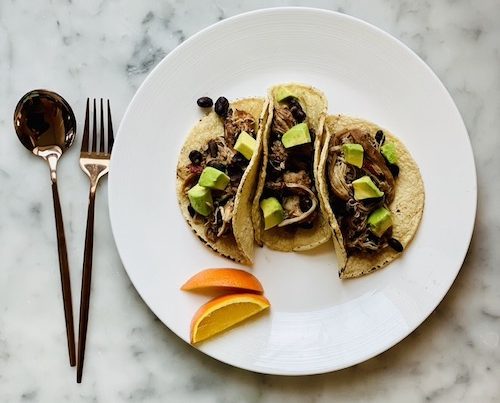 Chipotle orange chicken and beans in corn tortillas.