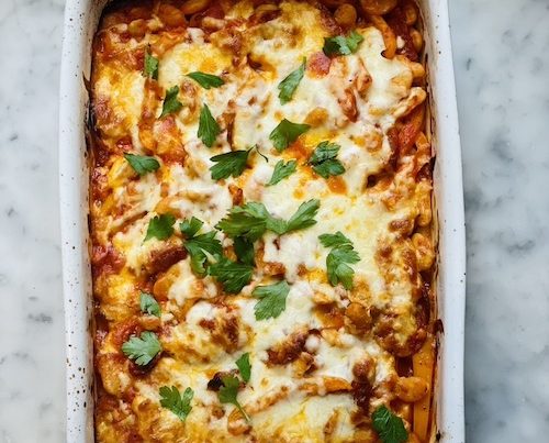 A white casserole dish of pizza bean bake.