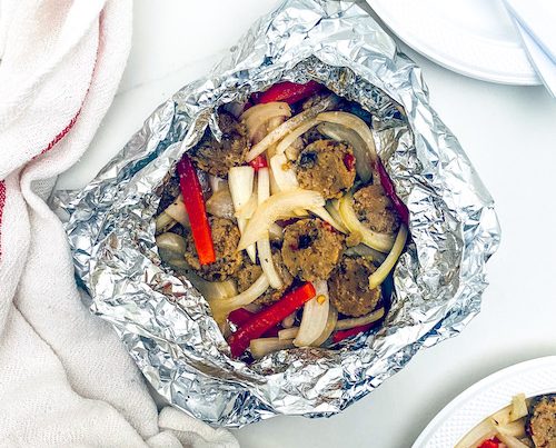 Sausage, peppers, and onions in a foil packet.