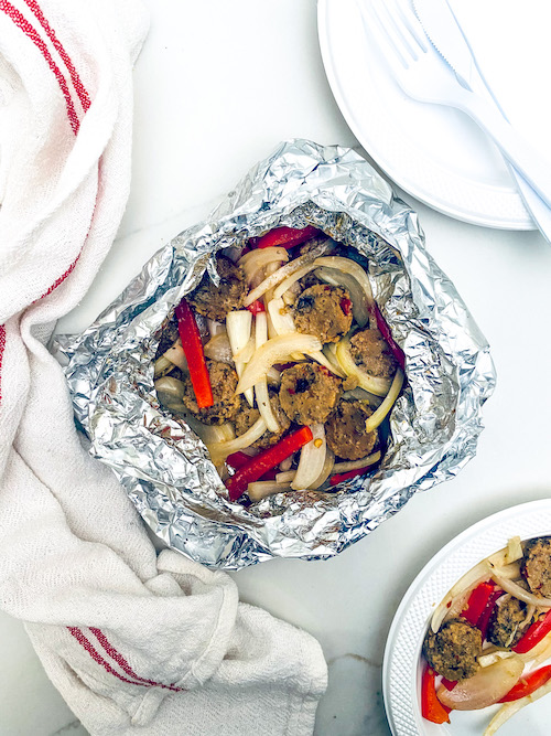 Sausage, peppers, and onions in a foil packet.