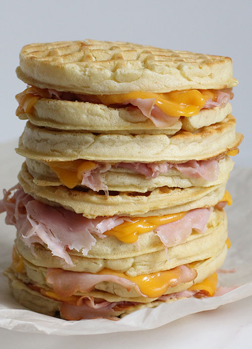 A stack of ham and cheese waffle sandwiches.
