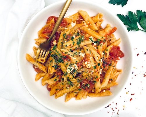 Viral TikTok feta pasta in a white bowl with a fork.