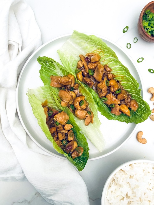 cashew chicken in lettuce wraps on a plate.