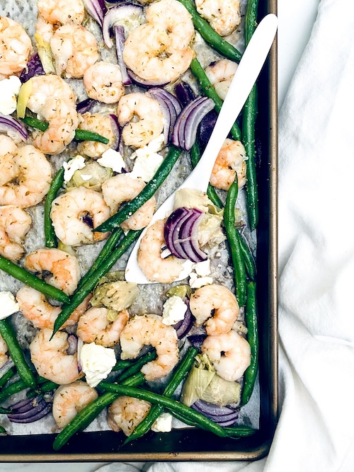 Shrimp and green beans on a sheet pan.