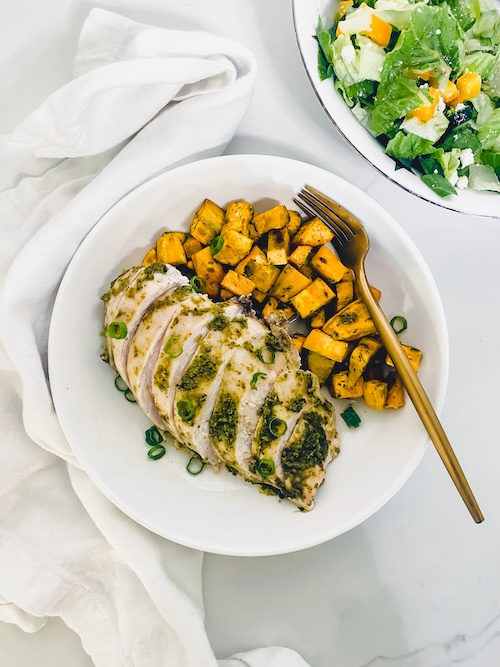 Pesto topped chicken breast with diced sweet potatoes.