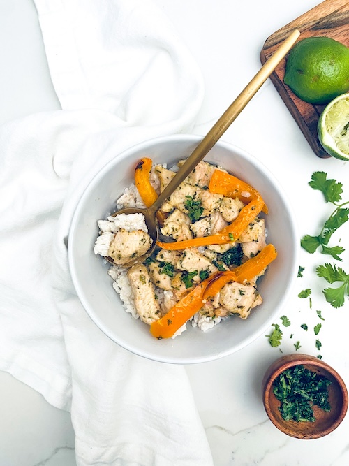 Chicken and bell peppers served over rice.