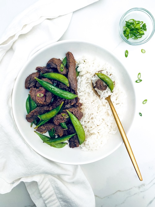 Japanese BBQ beef and rice on a white plate.