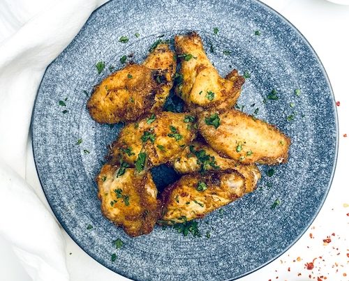 Thai chicken wings on a blue plate.