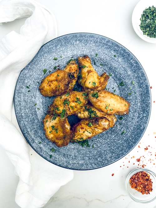 Thai chicken wings on a blue plate.