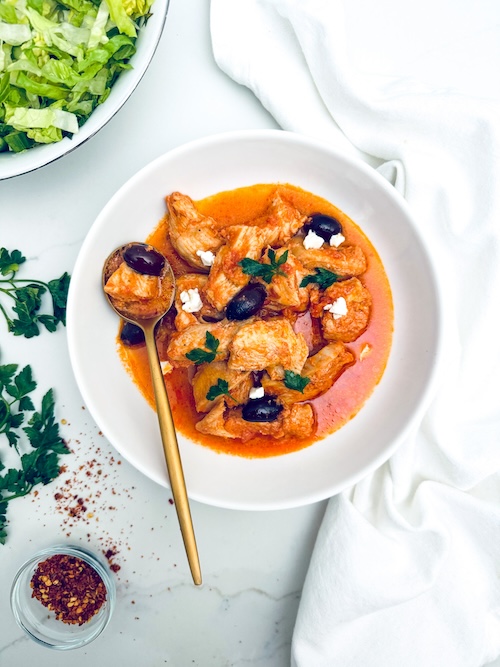 Feta and olive chicken in a bowl.