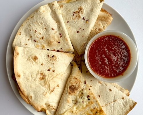 Pizza quesadilla on a plate.