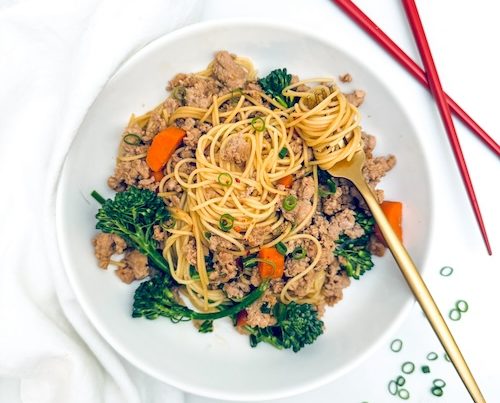 Pork and broccoli stir fry over noodles.