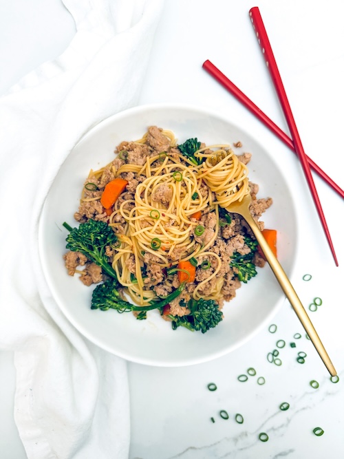 Pork and broccoli stir fry over noodles.