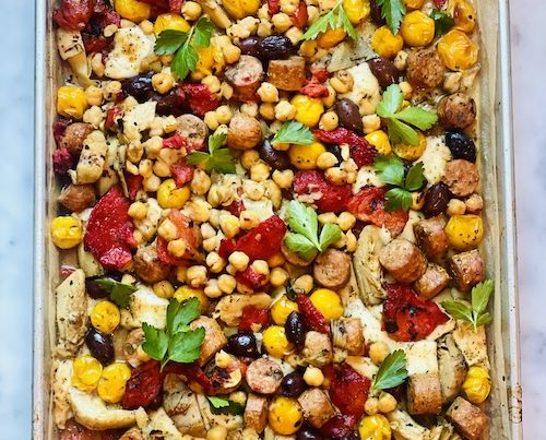 Antipasto sausage sheet pan meal on parchment paper.