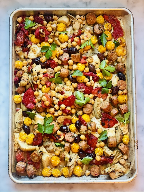 Antipasto sausage sheet pan meal on parchment paper.