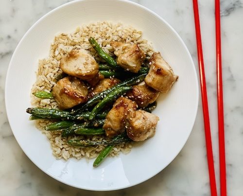 Sticky sesame chicken and green beans over brown rice.