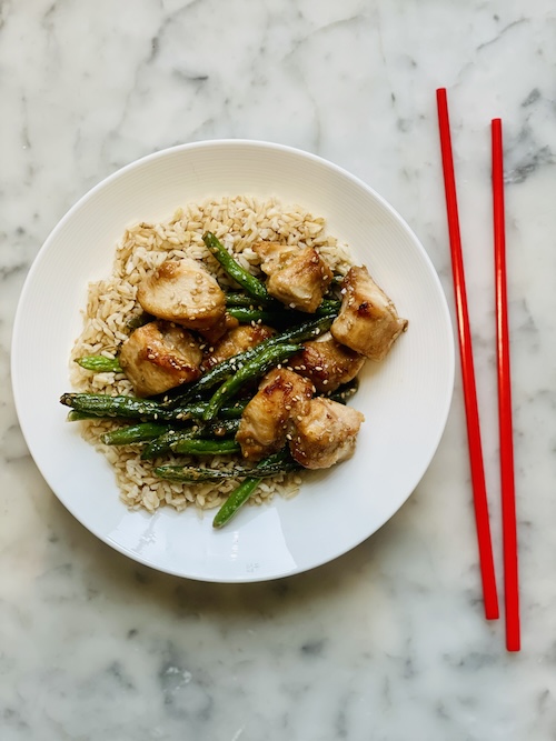 Sticky sesame chicken and green beans over brown rice.