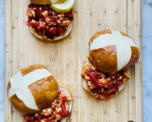 Vegan sloppy Joe sandwiches on a wooden board.
