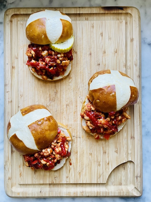 Vegan sloppy Joe sandwiches on a wooden board.