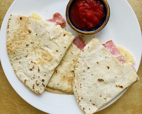 Hawaiian quesadilla corners on a plate.