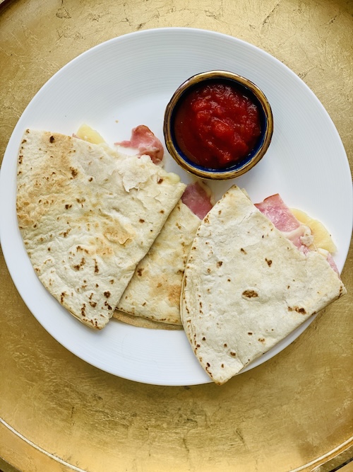 Hawaiian quesadilla corners on a plate.