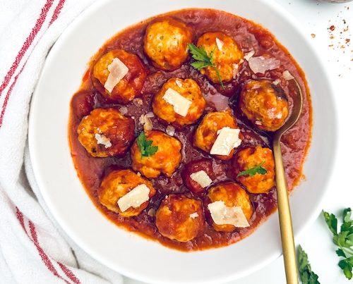 Healthy turkey meatballs and red sauce in a bowl.
