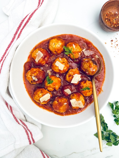 Healthy turkey meatballs and red sauce in a bowl.