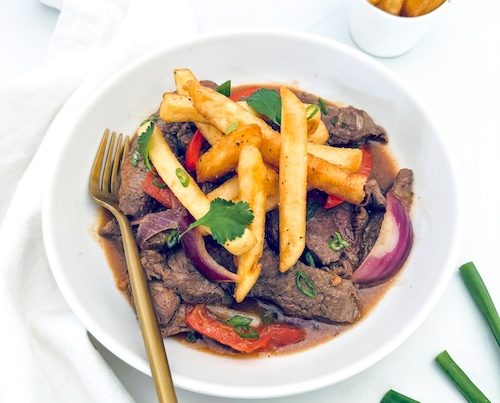 Stir fried beef and fries in a bowl.