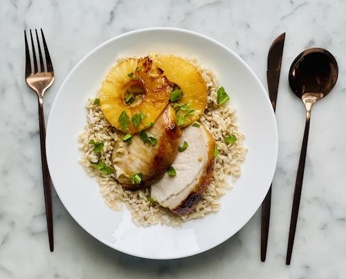 Sliced pork and pineapple over rice.