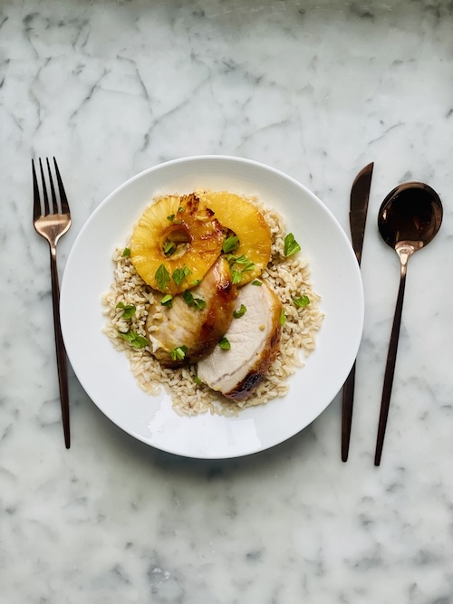 Sliced pork and pineapple over rice.